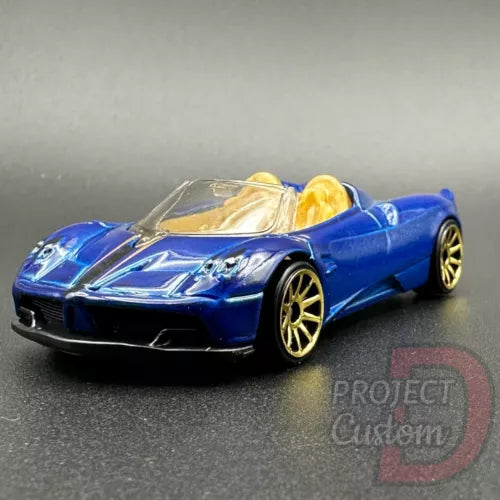 Blue roadster diecast car with gold wheels and interior