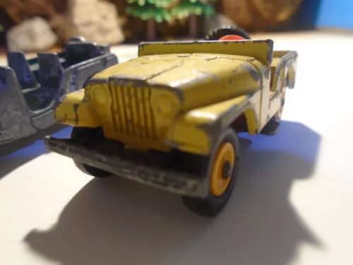 Yellow diecast toy jeep, front 3/4 view with open hood detail