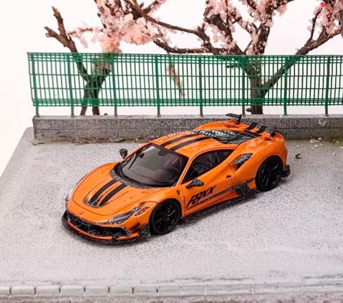 Orange sports car model diecast with black racing stripes and front splitter