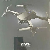 Grey quadcopter drone with four arms and spinning propellers