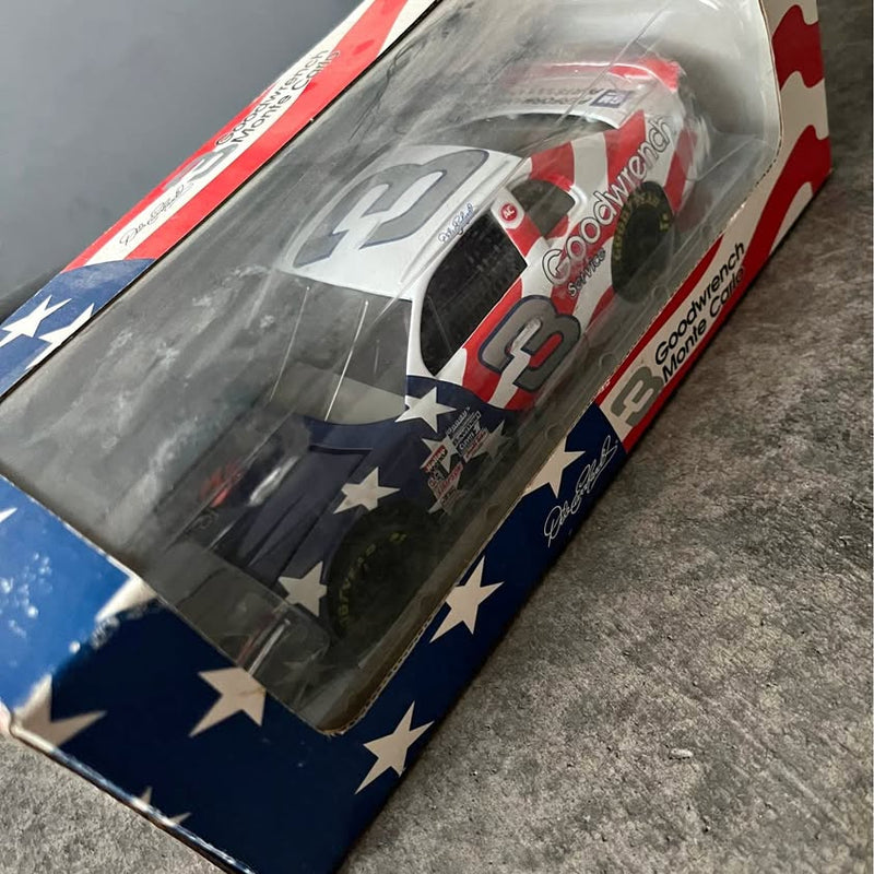 Packaged NASCAR diecast race car with No. 9 on gray hood, red/white accents