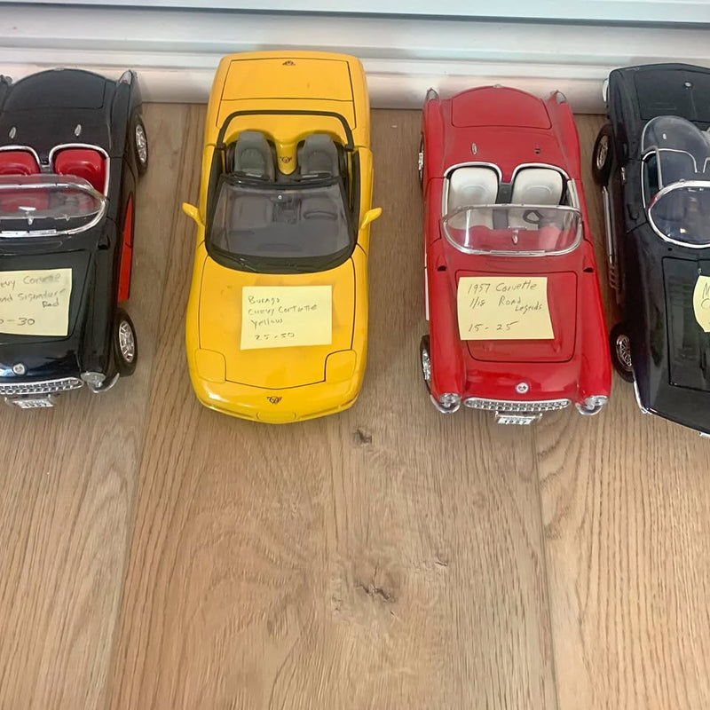Diecast toy car, yellow, front view with clear windshield and chrome bumper