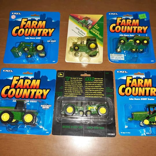 Set of six John Deere diecast toy tractors, 1/64 scale