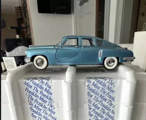 Metallic blue diecast mini car with whitewall tires and chrome bumpers
