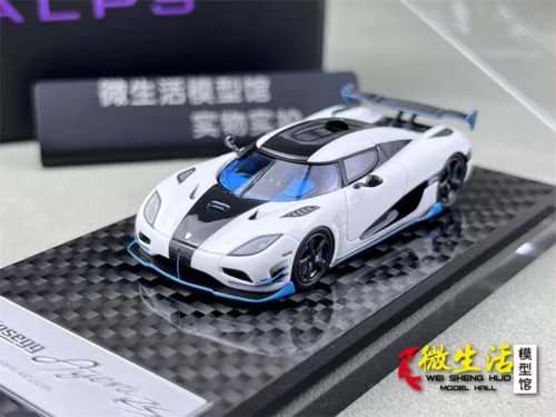 1:64 scale white racing car model with blue accents, on black display base