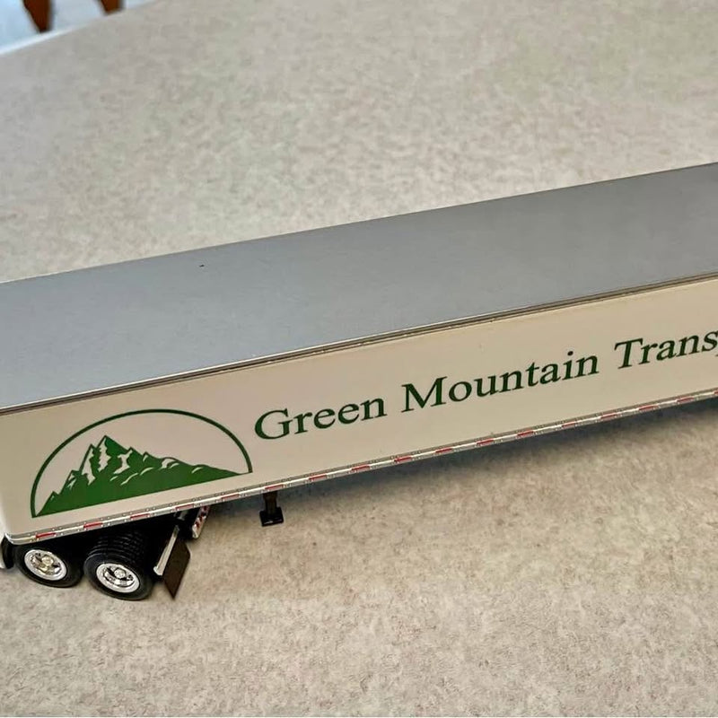 Diecast green tractor-trailer with Green Mountain Transportation logo and wheels
