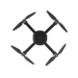 Quadcopter drone with four black propellers and rounded central body