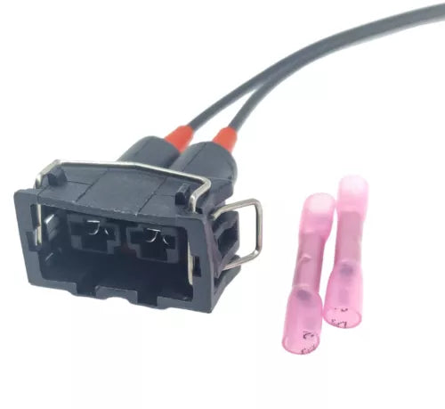 Plastic electrical connector with attached wires and two pink terminal covers