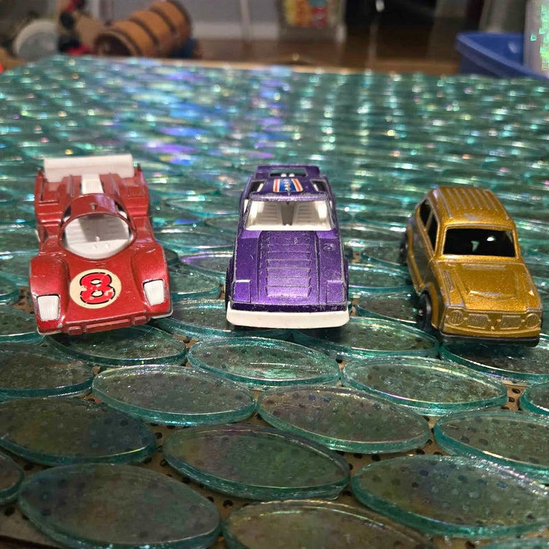 Vintage diecast toy race car set: red #8, purple, and gold cars