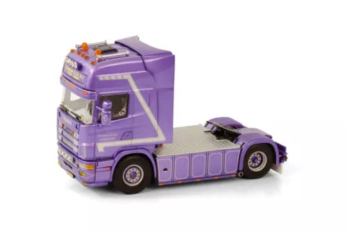Purple diecast truck cab model with chrome grille, amber lights, and detailed wheels