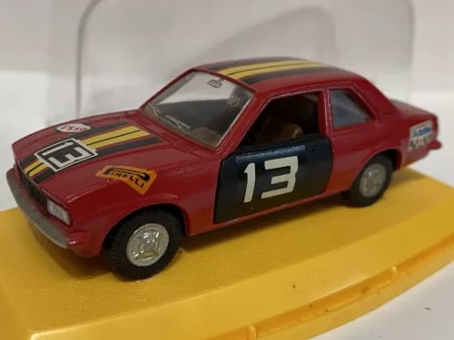 Red diecast rally car model with hood decals and number 13