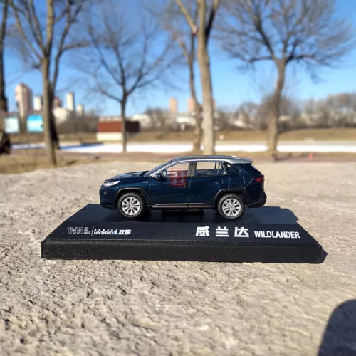 Blue SUV diecast model with silver roof on branded display base