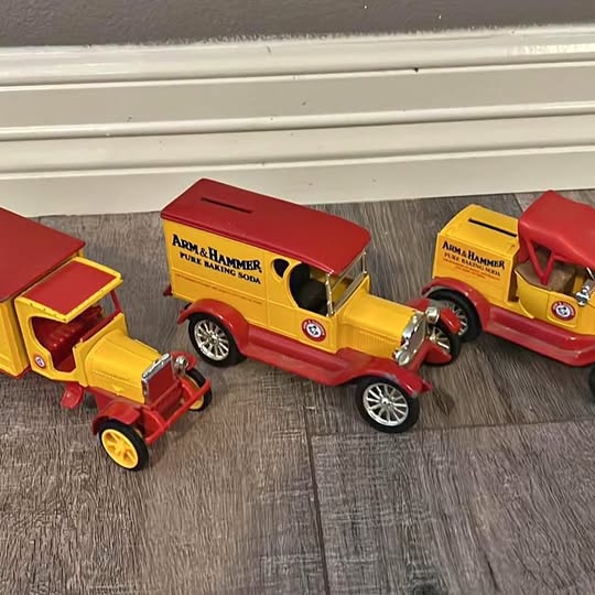 Diecast delivery trucks, red and yellow with Arm & Hammer logo and metal wheels
