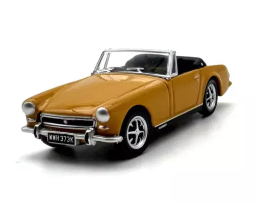 Gold convertible diecast sports car model with black interior, front three-quarter view