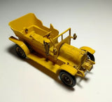 Vintage diecast car model in yellow with open seat and wheels