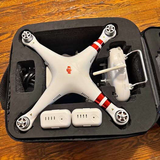 DJI Phantom 3 drone with four propellers and landing struts, in carrying case