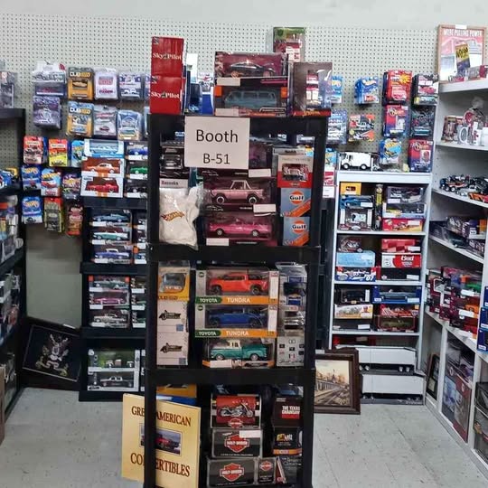Diecast car display booth with multiple boxed model cars