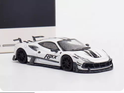 White and black diecast race car model toy, front 3/4 view with FXX graphics
