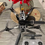Black and gray drone with four propellers and front camera module.
