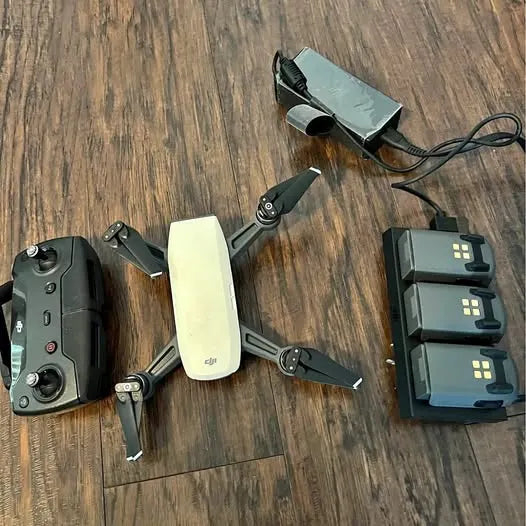 DJI Spark drone with controller and spare batteries, folded quadcopter