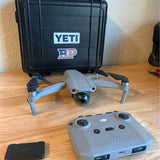 Grey DJI drone with controller and accessories in protective hard case