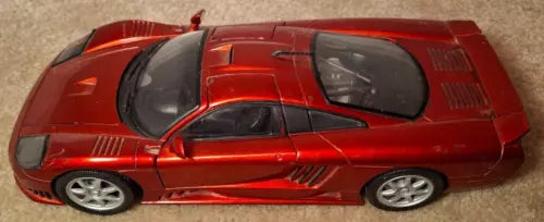 Red 1:18 scale diecast sports car with hood scoop, black windows, and silver wheels