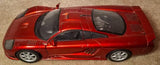 Red 1:18 scale diecast sports car with hood scoop, black windows, and silver wheels