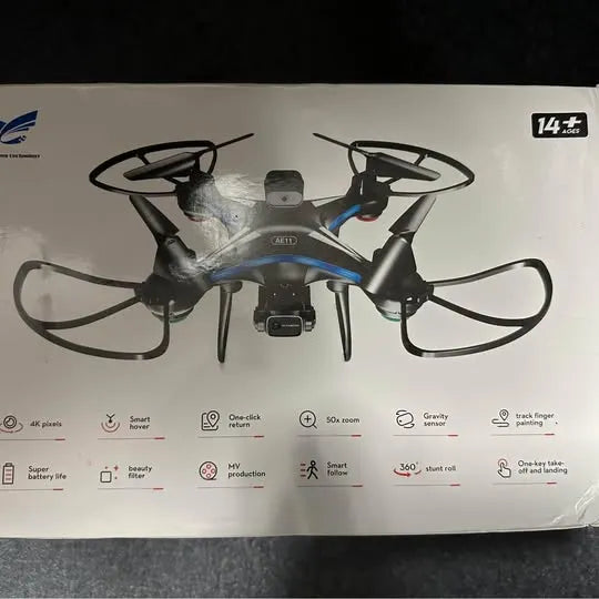 Blue and gray quadcopter drone with four rotors on retail box front