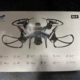 Blue and gray quadcopter drone with four rotors on retail box front
