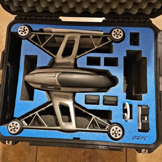 Quadcopter drone in foam-lined hard case with four prop arms and camera module