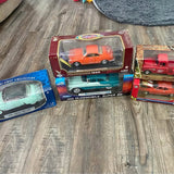 Diecast car set in display boxes with clear windows, orange, red, and teal cars