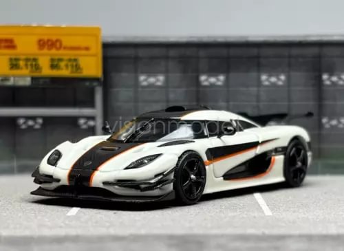 Diecast sports car model with white body, black hood, and orange racing stripes