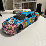 NASCAR diecast race car with colorful graffiti-style livery, blue body, front view