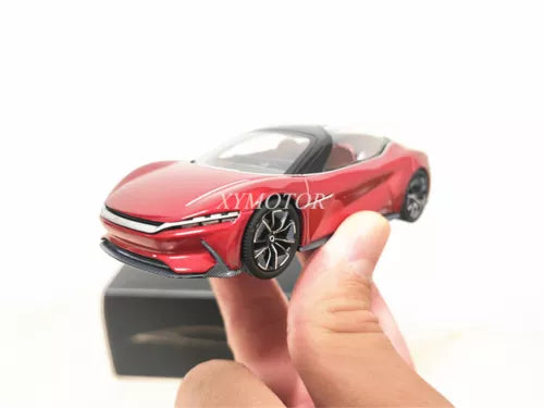 Red diecast concept car model with detailed front grille, headlights, and wheels
