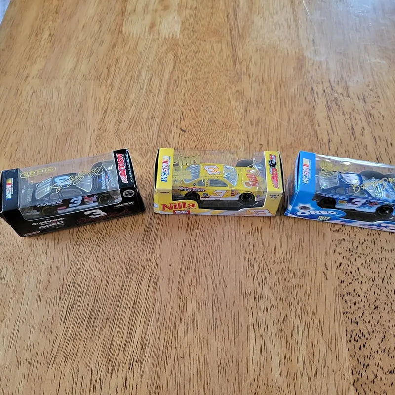 1:64 NASCAR diecast car set, three boxed cars with blue, yellow, and black designs