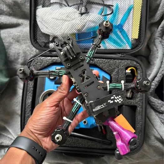 FPV drone frame with motor mounts and wiring in open carrying case
