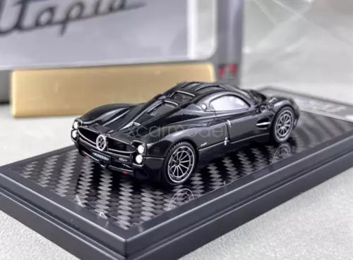 1:64 scale black carbon sports coupe diecast model car on display base