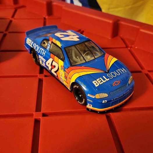 Blue racing diecast car with number 42 and sponsor decals