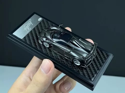 1:64 scale gray racing diecast model car in display box with black insert