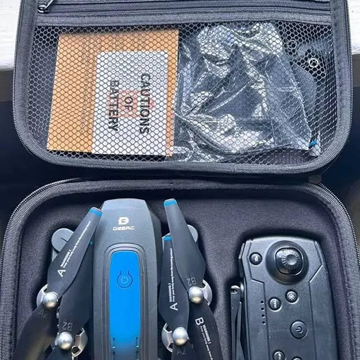 DEERC drone and remote controller in black zippered carrying case with blue buttons
