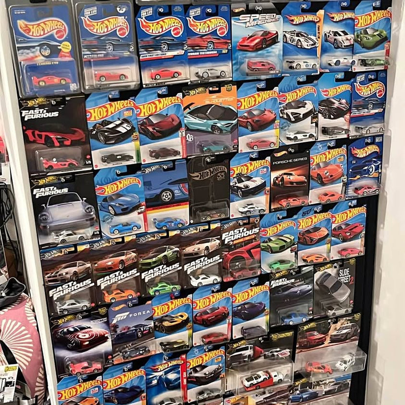Hot Wheels diecast car assortment on blister cards in a display rack