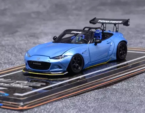 Blue roadster diecast model car with black rear wing and open-top cabin