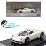 White diecast coupe model car with black wheels and side stripes on display base