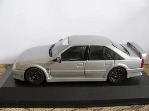 Silver-gray diecast coupe model with black wheels and side decals