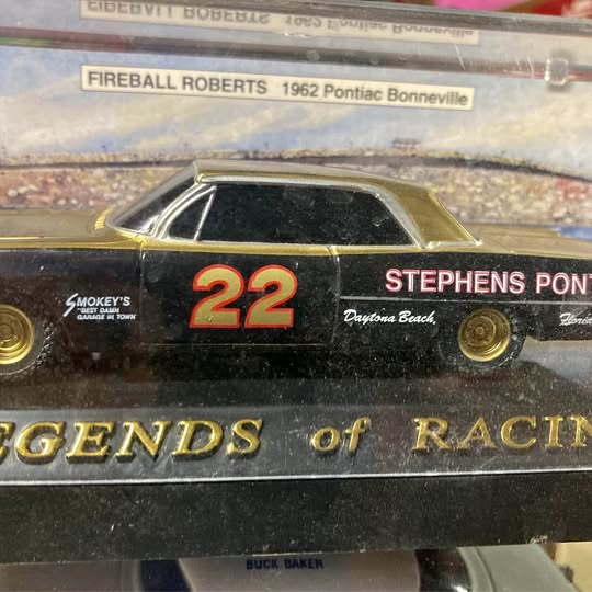 Black diecast race car with yellow roof, number 22, front side view