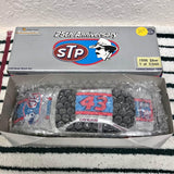 1:24 diecast race car in retail box, blue and red STP-style graphics