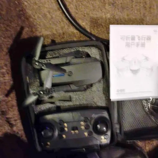 Drone inside carrying case with remote controller and propeller guards
