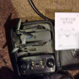 Drone inside carrying case with remote controller and propeller guards