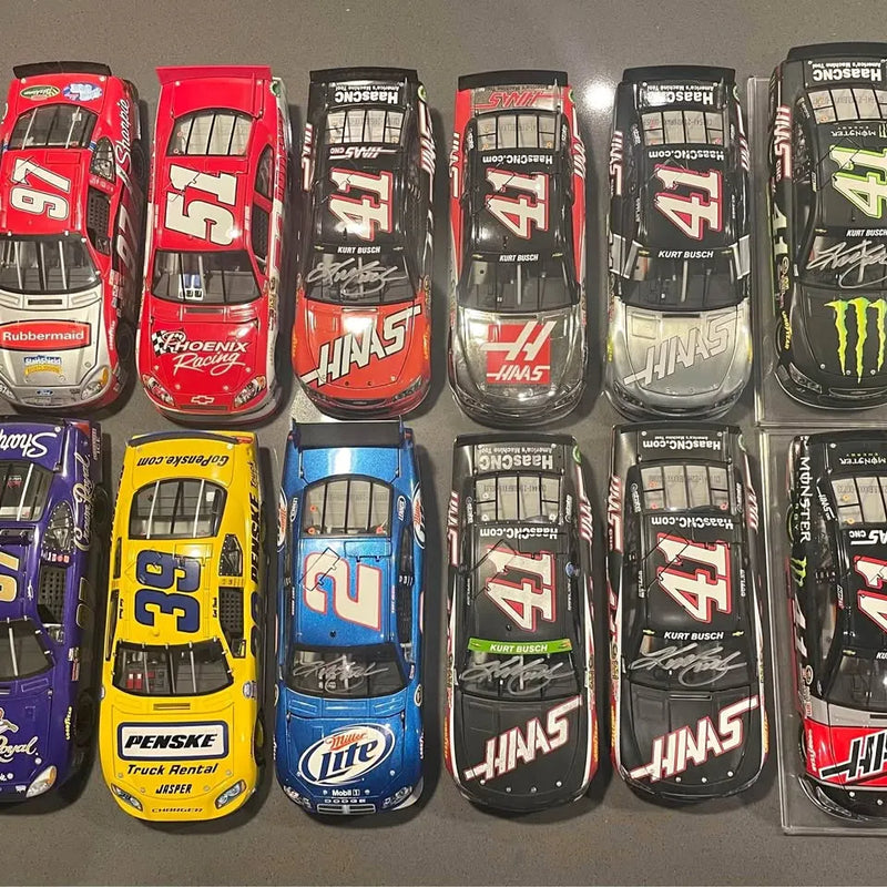 Loose 1/24 NASCAR diecast race cars, multiple styles in red, black, blue, and yellow