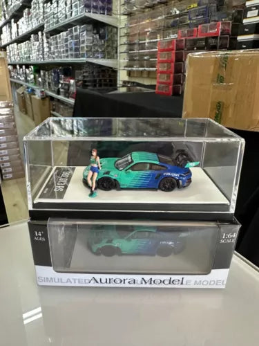 1/64 scale Aurora diecast model car with figure, blue and teal racing design in box